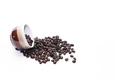 Close-up of coffee beans against white background