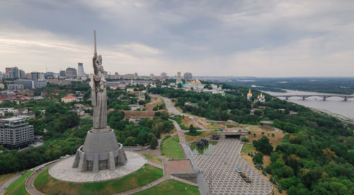 High angle view of buildings against cloudy sky