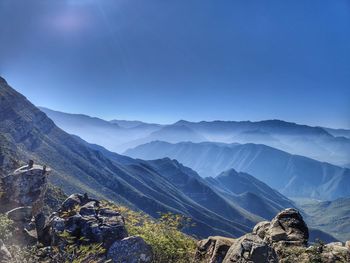 Scenic view of mountains against blue sky