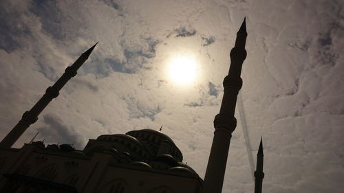 Low angle view of cross on building against sky