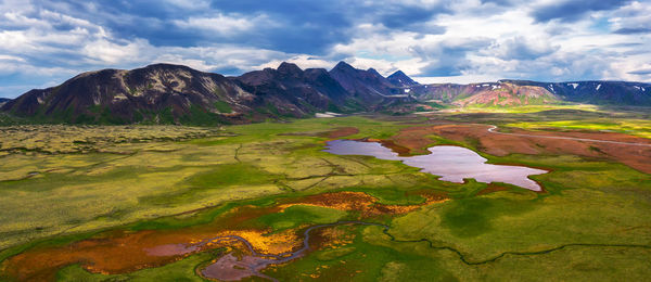 Scenic view of lake and mountains against sky