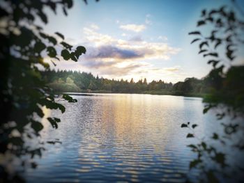 Scenic view of lake against sky at sunset