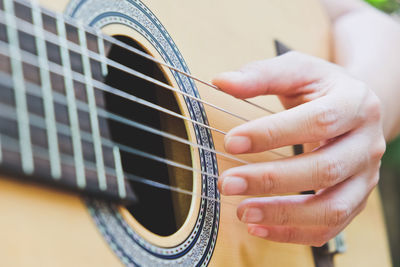 Cropped image of man playing guitar