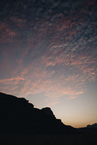 Scenic view of silhouette mountain against dramatic sky