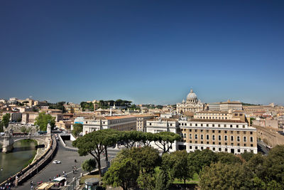 Buildings in city against blue sky