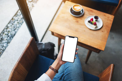 Midsection of woman using mobile phone