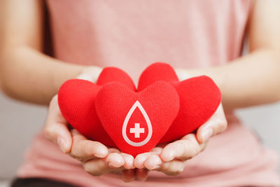 Close-up of woman holding heart shape with hands