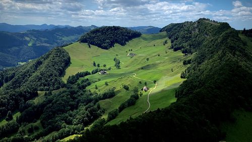 High angle view of green landscape against sky