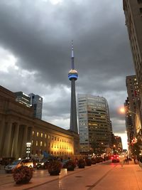 View of buildings in city against cloudy sky