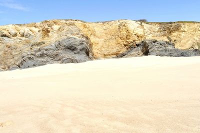 Scenic view of sand dunes against sky