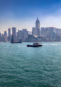 View of sea against buildings in city