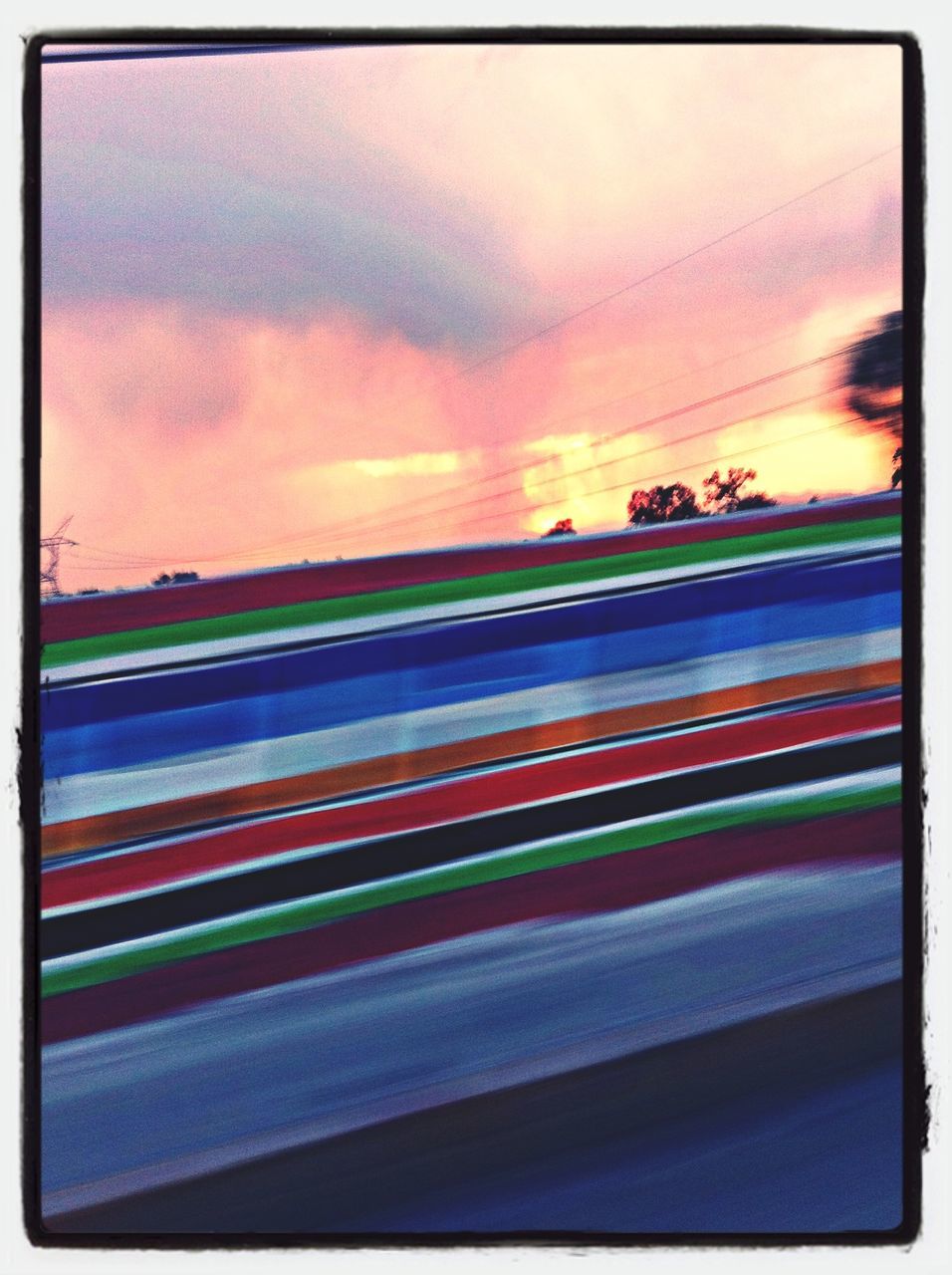 transfer print, transportation, auto post production filter, sky, cloud - sky, land vehicle, car, mode of transport, road, multi colored, cloudy, sunset, blurred motion, road marking, illuminated, street, no people, cloud, outdoors, dusk