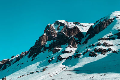 Scenic view of snowcapped mountain against blue sky