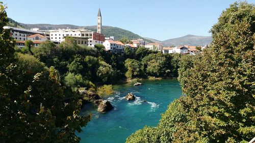 Scenic view of river and buildings in town