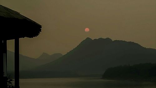 Low angle view of silhouette mountains against sky during sunset