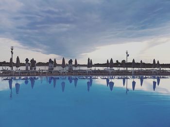 Group of people on swimming pool against sky