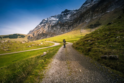 Man standing by mountain against sky