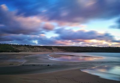 View of beach against cloudy sky