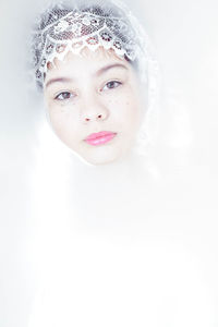 Portrait of a smiling young woman over white background