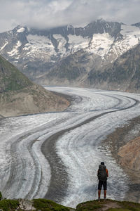 Rear view of man walking on road