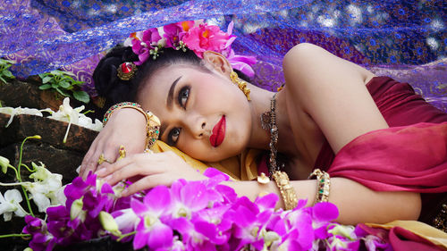 Close-up of woman lying on flowers