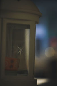 Close-up of cross on glass