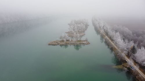 High angle view of trees by lake during winter