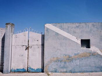 Low angle view of building against clear blue sky