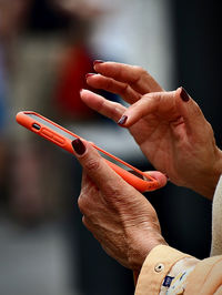 Cropped hand of man holding thermometer