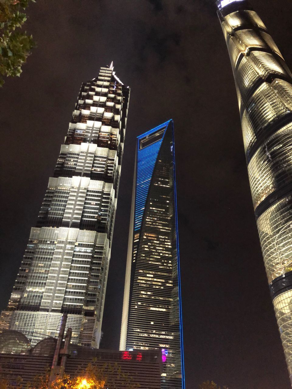 LOW ANGLE VIEW OF ILLUMINATED BUILDINGS AGAINST SKY