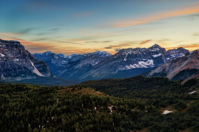 Scenic view of snowcapped mountains against sky during sunset