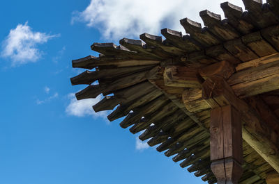 Low angle view of wooden house roof against sky