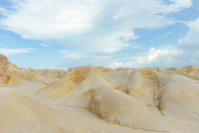 Scenic view of arid landscape against sky