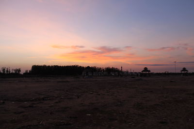 Scenic view of silhouette field against sky during sunset