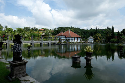 Scenic view of lake by building against sky