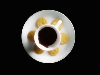 Directly above shot of coffee served on black background