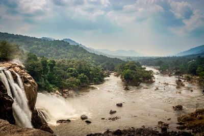 Scenic view of waterfall against sky