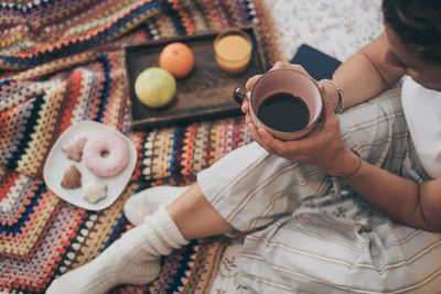 High angle view of hand holding coffee cup