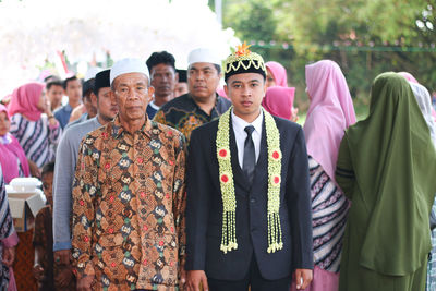 Portrait of bridegroom with family