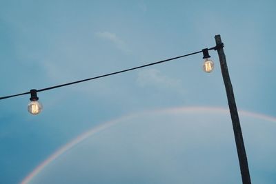 Low angle view of rainbow over street lamp