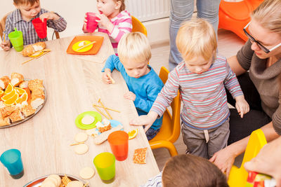 High angle view of people sitting on table