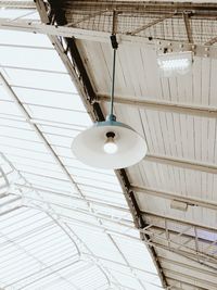 Low angle view of pendant light on roof