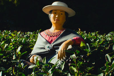 View of statue against plants on field