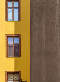 Low angle view of yellow window on wall
