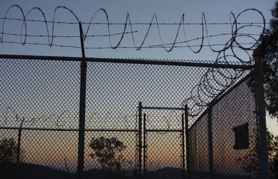 Barbed wire fence against sky
