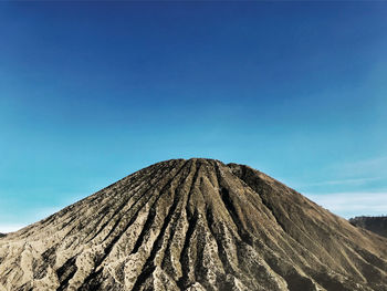 Low angle view of volcanic mountain against clear blue sky,bromo mountain in indonesia.