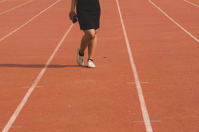 Low section of man running on street