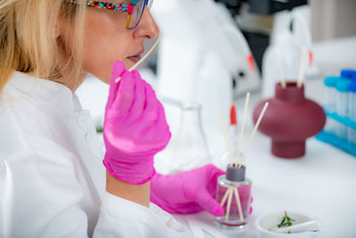 Perfumer holding a stick with aromatic oil.