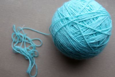 Close-up of blue woolen ball on table