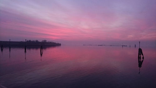 Scenic view of lake against sky during sunset